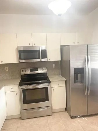 a stove top oven sitting inside of a kitchen