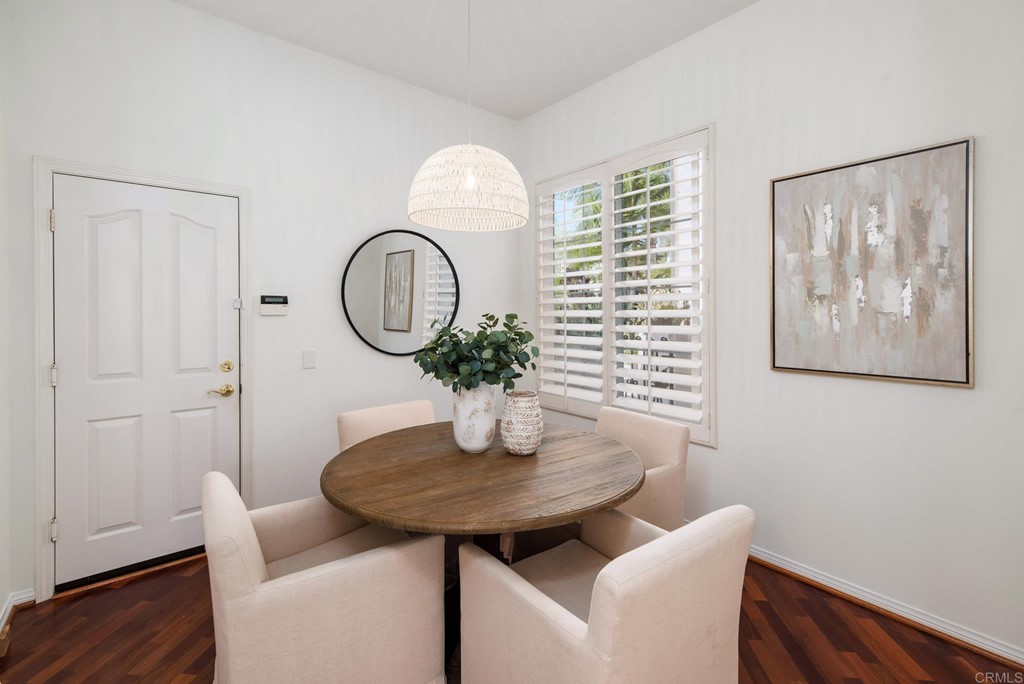 1368 Corvidae Street Carlsbad, CA 92011 - Photo 13 of 38 a view of a room that has a table and a chair with wooden floor
