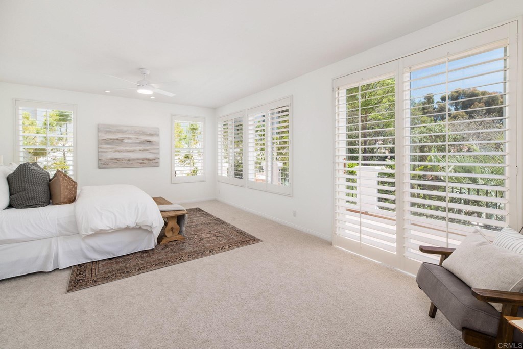 1368 Corvidae Street Carlsbad, CA 92011 - Photo 19 of 38 a spacious bedroom with a large bed and a large window