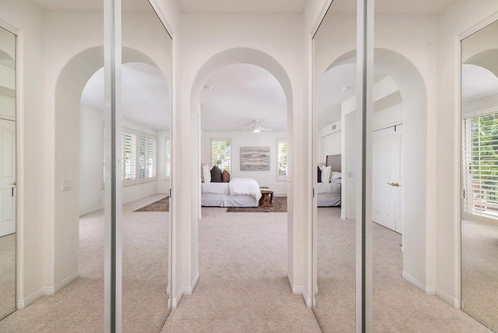 1368 Corvidae Street Carlsbad, CA 92011 - Photo 23 of 38 a view of a hallway with a livingroom and a livingroom with furniture