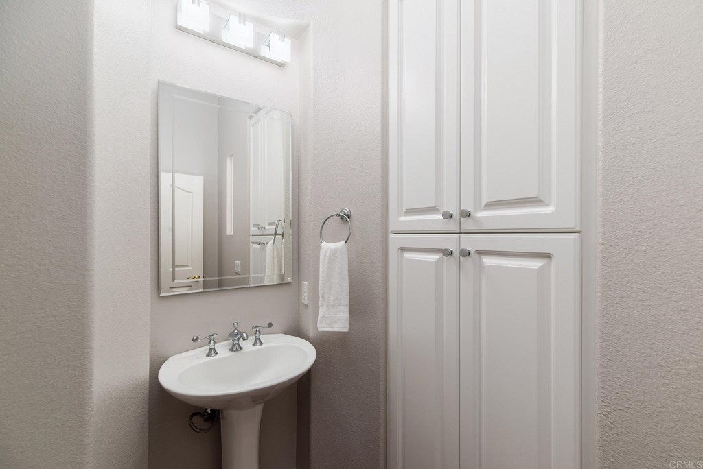 1368 Corvidae Street Carlsbad, CA 92011 - Photo 25 of 38 a bathroom with a sink a mirror and shower