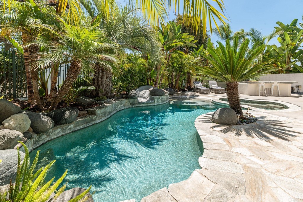 1368 Corvidae Street Carlsbad, CA 92011 - Photo 32 of 38 a view of a backyard with plants and palm trees