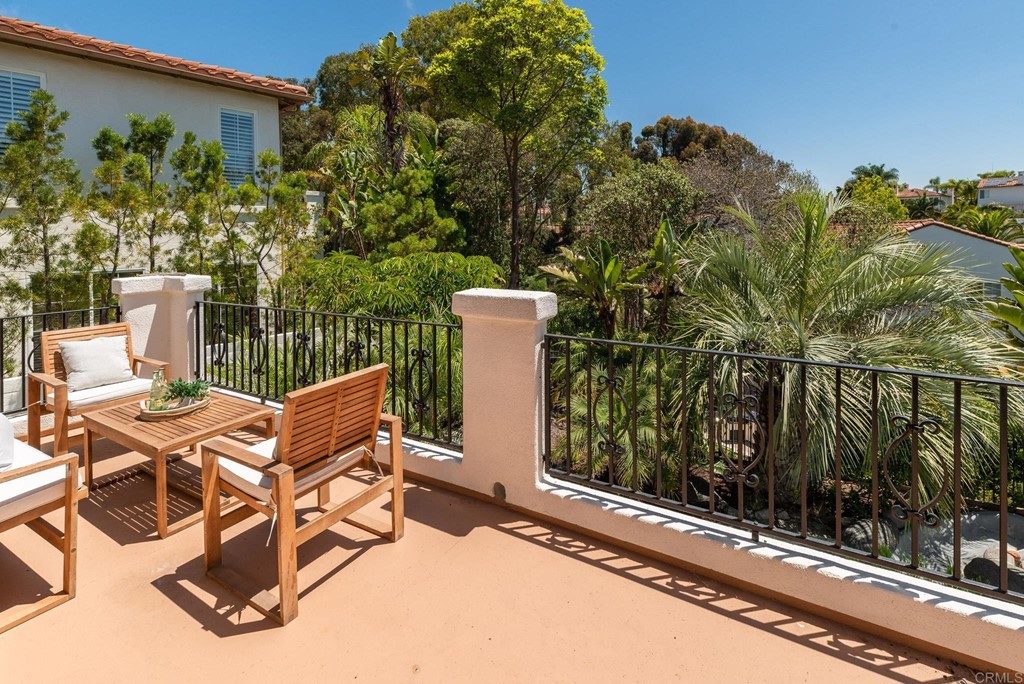 1368 Corvidae Street Carlsbad, CA 92011 - Photo 34 of 38 a view of a patio with table and chairs with wooden floor and fence