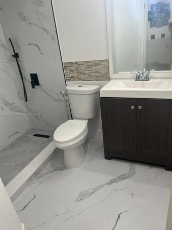 a bathroom with a toilet sink and mirror