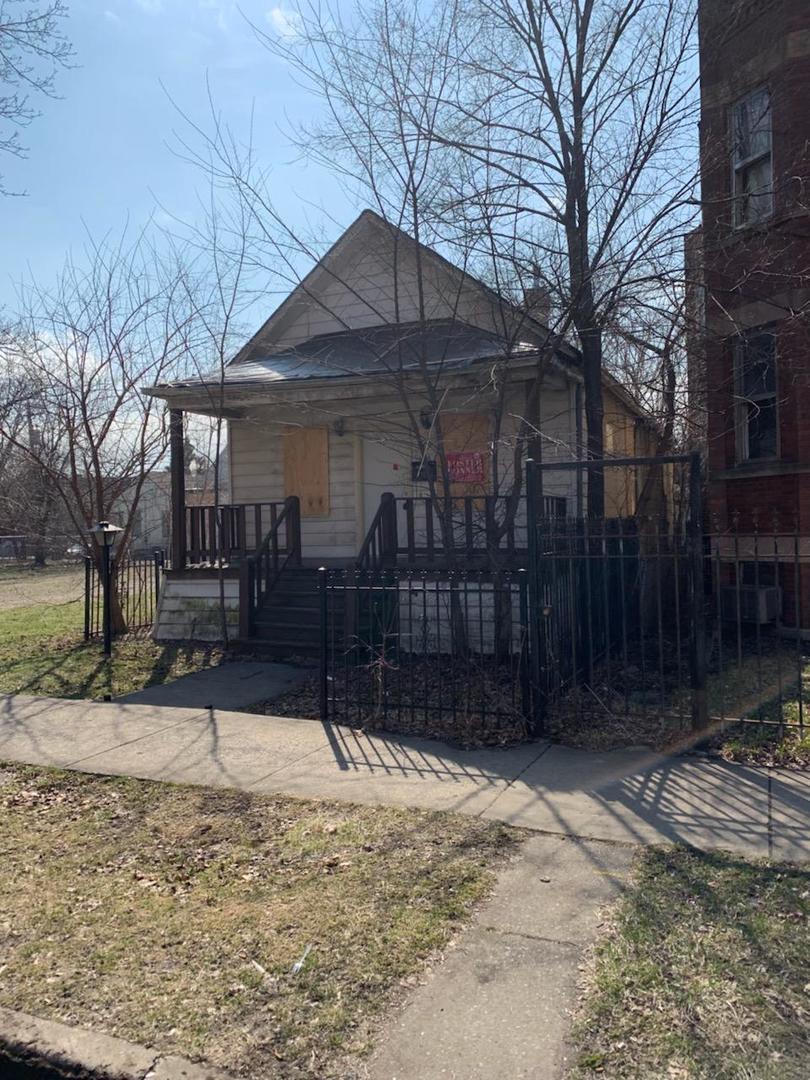7110 South Champlain Avenue Chicago, IL 60619 - Photo 1 of 13 a street view with wooden fence