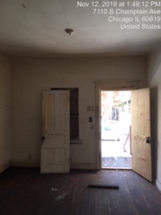 7110 South Champlain Avenue Chicago, IL 60619 - Photo 2 of 13 an empty room with windows