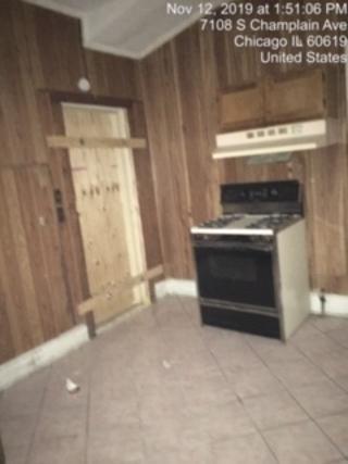 7110 South Champlain Avenue Chicago, IL 60619 - Photo 5 of 13 a room with a fireplace and a rug