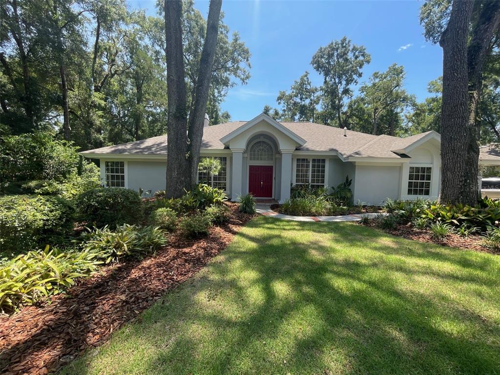 9613 Southwest 53rd Road Gainesville, FL 32608 - Photo 1 of 1 a front view of a house with yard and green space