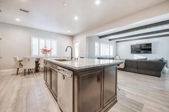 a kitchen with a stove and a wooden floor