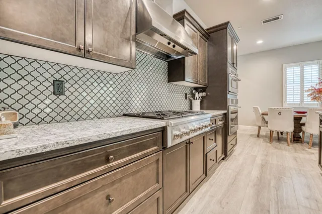 a kitchen with a sink stove and cabinets