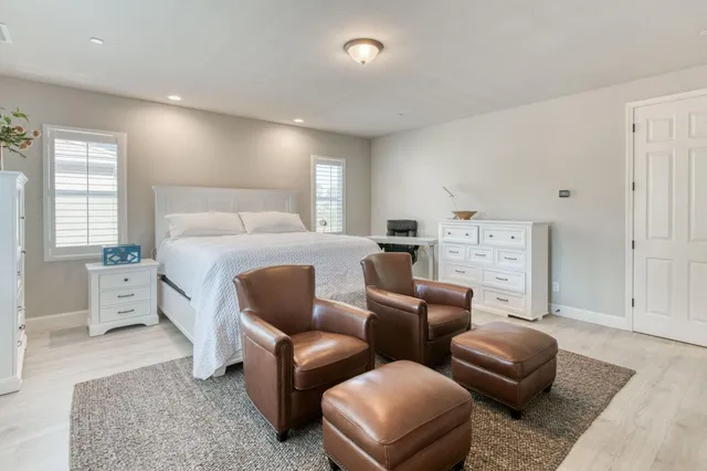 a spacious bathroom with a double vanity sink a mirror and a bathtub