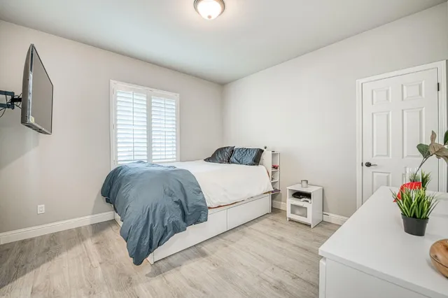 a bedroom with a bed and a window