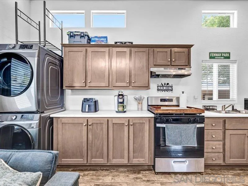 14291 Rios Canyon Road, Unit 3 El Cajon, CA 92021 - Photo 11 of 16 a kitchen with stainless steel appliances granite countertop a stove and a sink