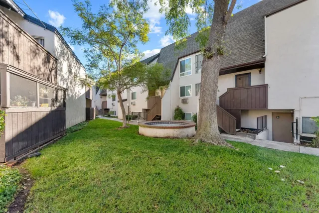 a view of a house with a yard and a patio