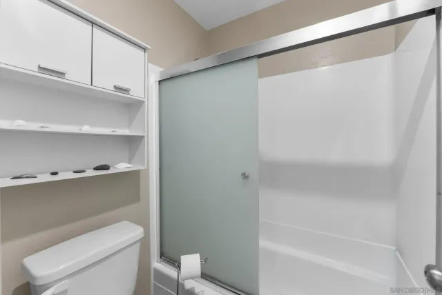 a bathroom with a toilet and a bathtub