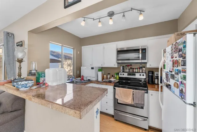 a kitchen with stainless steel appliances granite countertop a sink stove and microwave