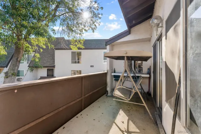 a view of a room with wooden floor and furniture