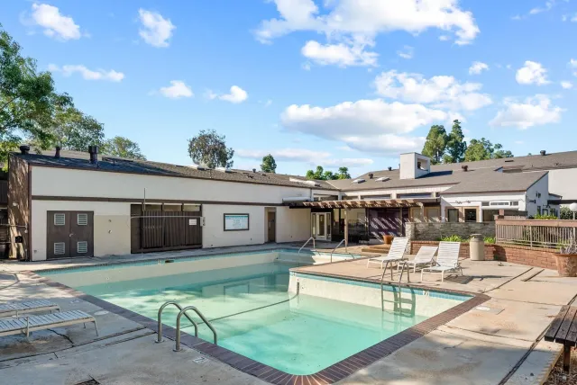 a view of a patio with dining table and chairs with wooden floor