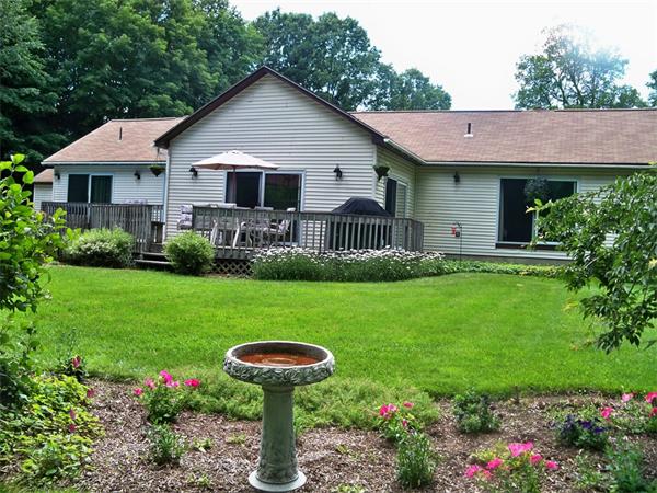 284 Mountain Road Gill, MA 01354 - Photo 1 of 28 a front view of a house with garden