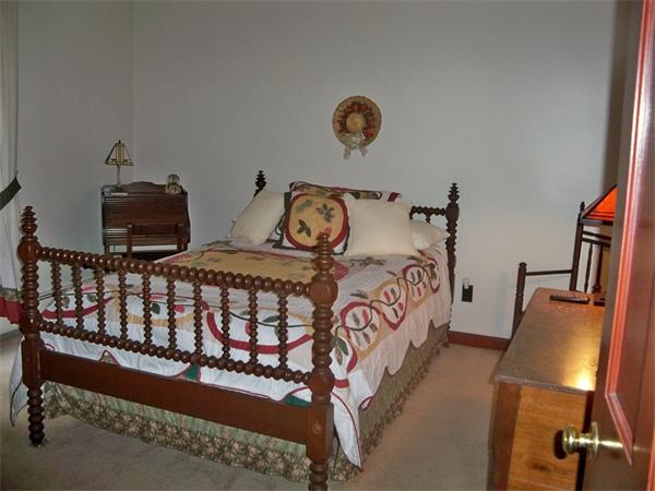 284 Mountain Road Gill, MA 01354 - Photo 15 of 28 a bedroom with bed and a chandelier