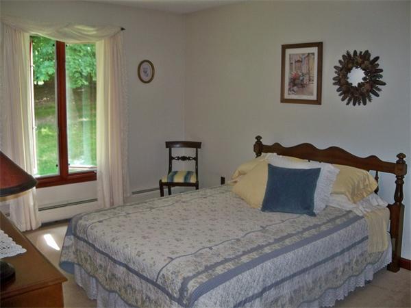 284 Mountain Road Gill, MA 01354 - Photo 17 of 28 a bedroom with a bed and a window