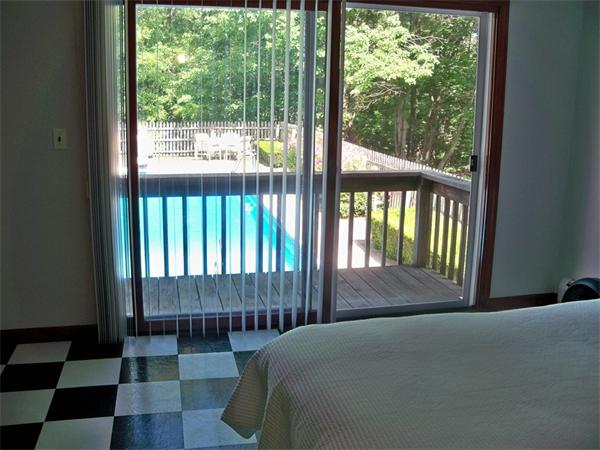 284 Mountain Road Gill, MA 01354 - Photo 19 of 28 a bedroom with a bed and a view of a garden