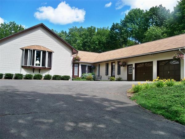 284 Mountain Road Gill, MA 01354 - Photo 2 of 28 a front view of a house with a yard and garage