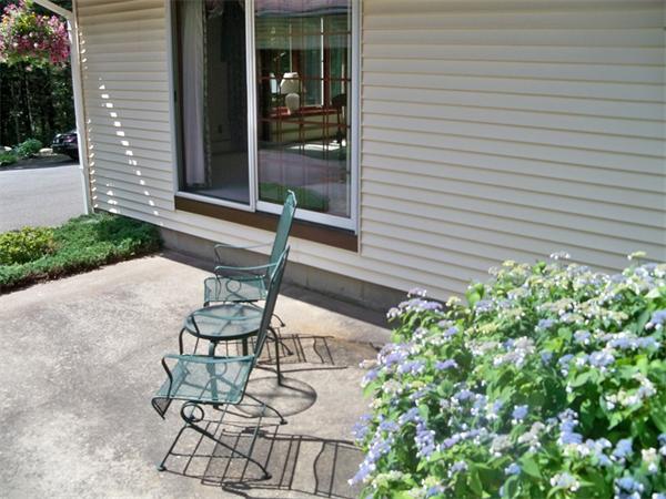 284 Mountain Road Gill, MA 01354 - Photo 24 of 28 a view of a chair and table in backyard of the house