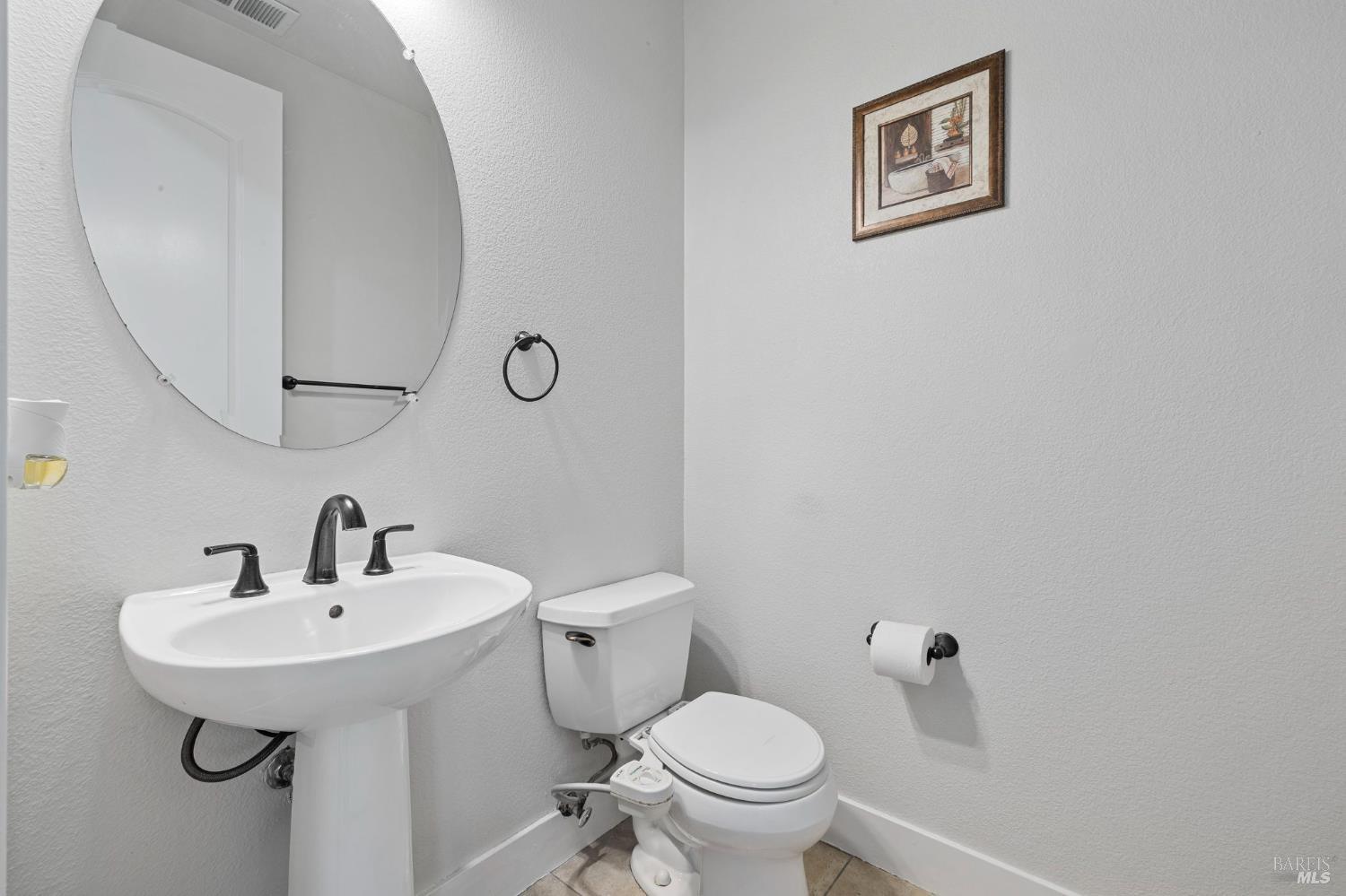 1461-1463 Trombetta Street Santa Rosa, CA 95407 - Photo 13 of 53 a bathroom with a sink mirror and toilet