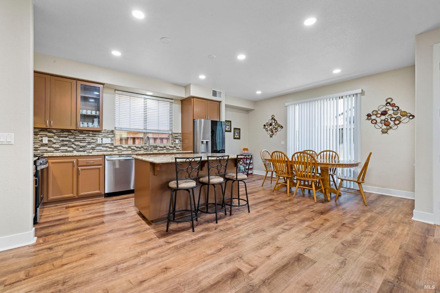 1461-1463 Trombetta Street Santa Rosa, CA 95407 - Photo 18 of 53 a open kitchen with stainless steel appliances granite countertop a table chairs sink and cabinets