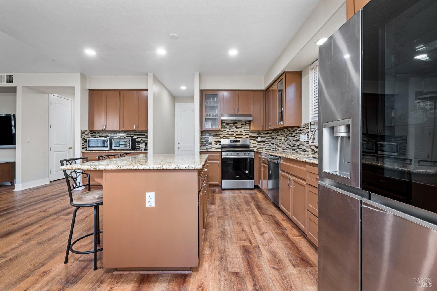 1461-1463 Trombetta Street Santa Rosa, CA 95407 - Photo 20 of 53 a kitchen with stainless steel appliances granite countertop a stove top oven a sink a counter space and cabinets