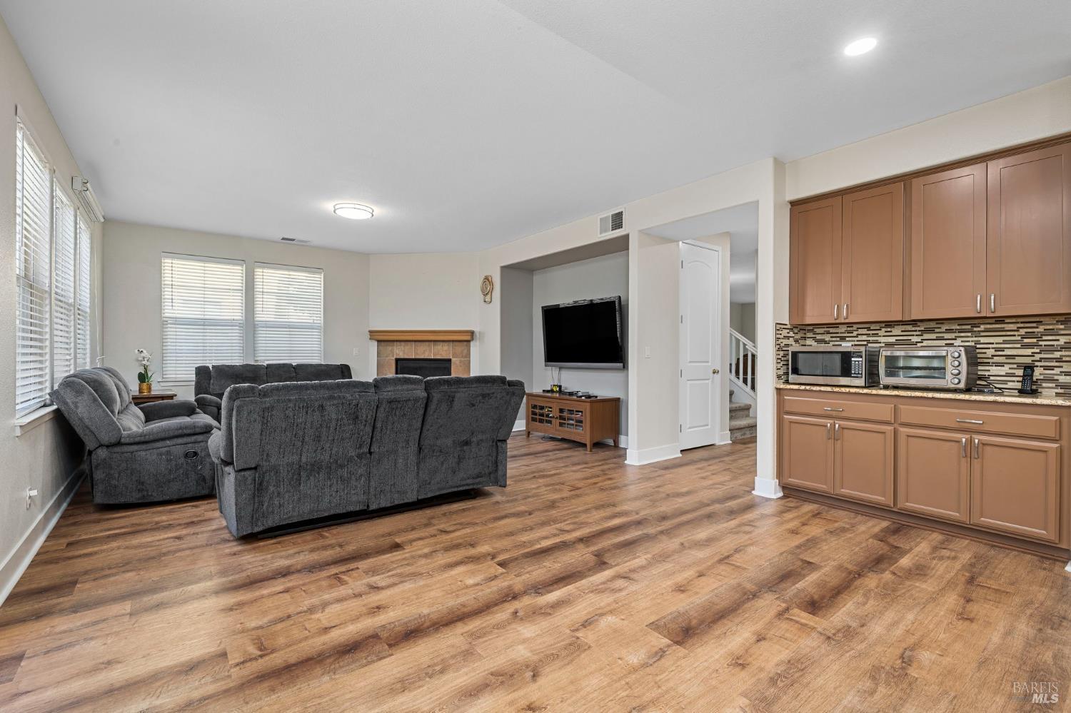 1461-1463 Trombetta Street Santa Rosa, CA 95407 - Photo 21 of 53 a living room with furniture flat screen tv and a refrigerator