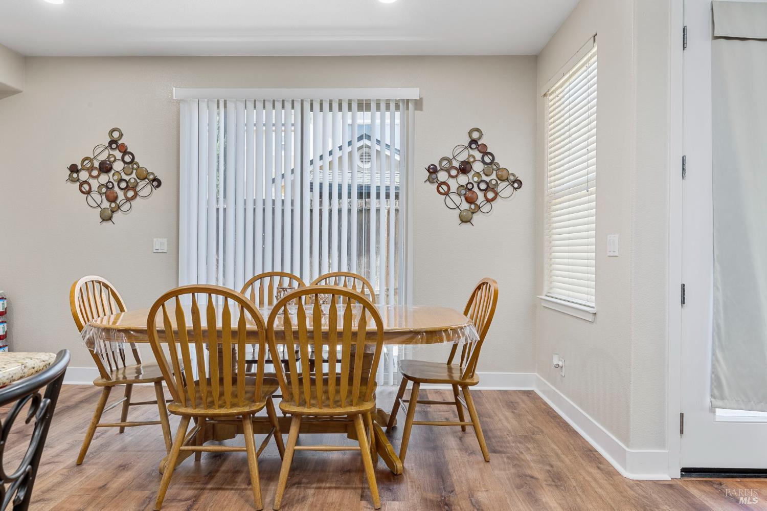 1461-1463 Trombetta Street Santa Rosa, CA 95407 - Photo 24 of 53 a view of a dining room with furniture a chandelier and wooden floor