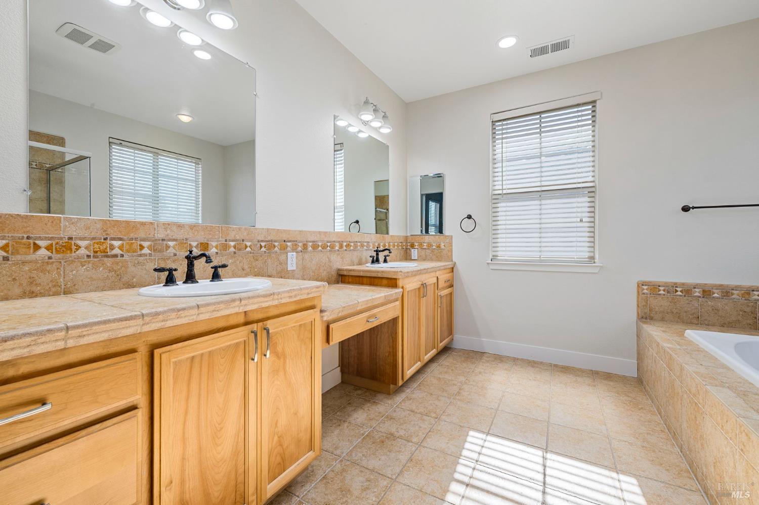 1461-1463 Trombetta Street Santa Rosa, CA 95407 - Photo 33 of 53 a spacious bathroom with a tub sink and mirror