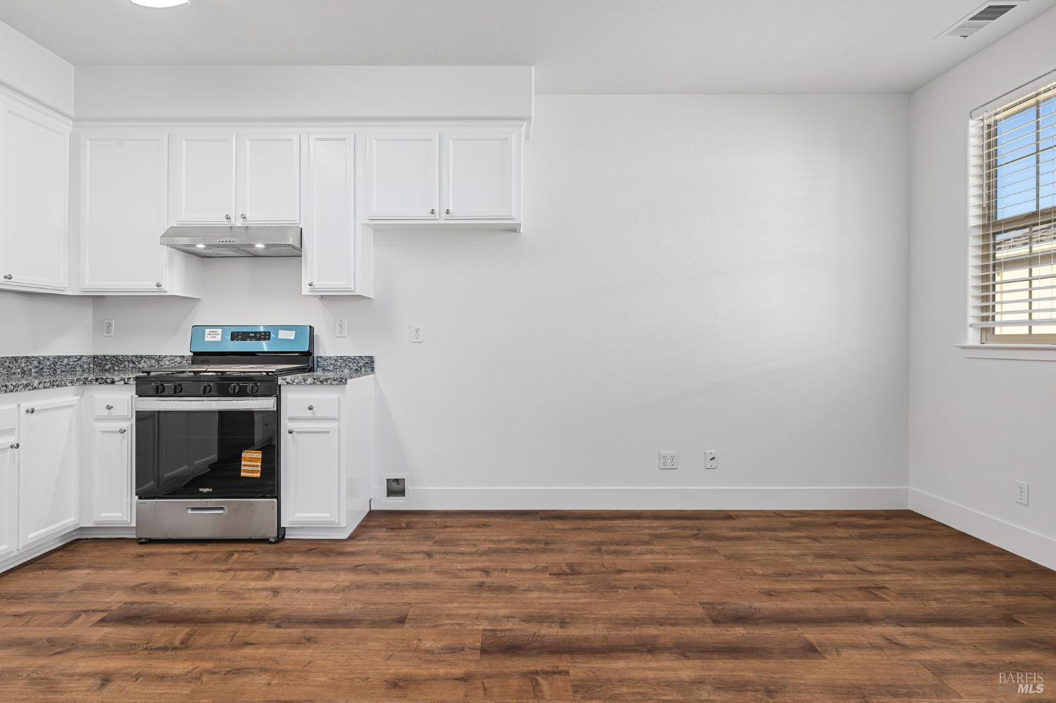 1461-1463 Trombetta Street Santa Rosa, CA 95407 - Photo 36 of 53 a kitchen with granite countertop a stove and a sink