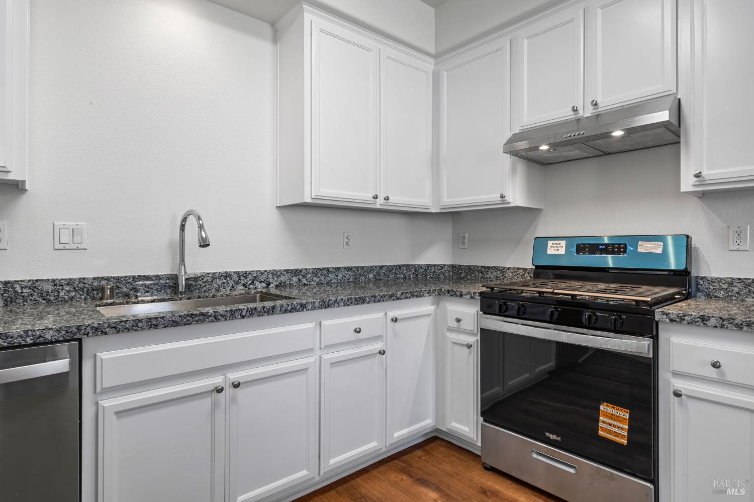 1461-1463 Trombetta Street Santa Rosa, CA 95407 - Photo 39 of 53 a kitchen with granite countertop white cabinets and a stove