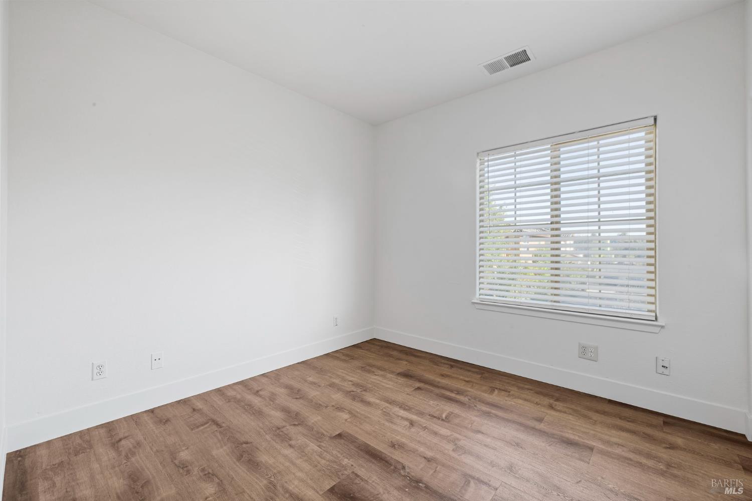 1461-1463 Trombetta Street Santa Rosa, CA 95407 - Photo 40 of 53 an empty room with wooden floor and windows