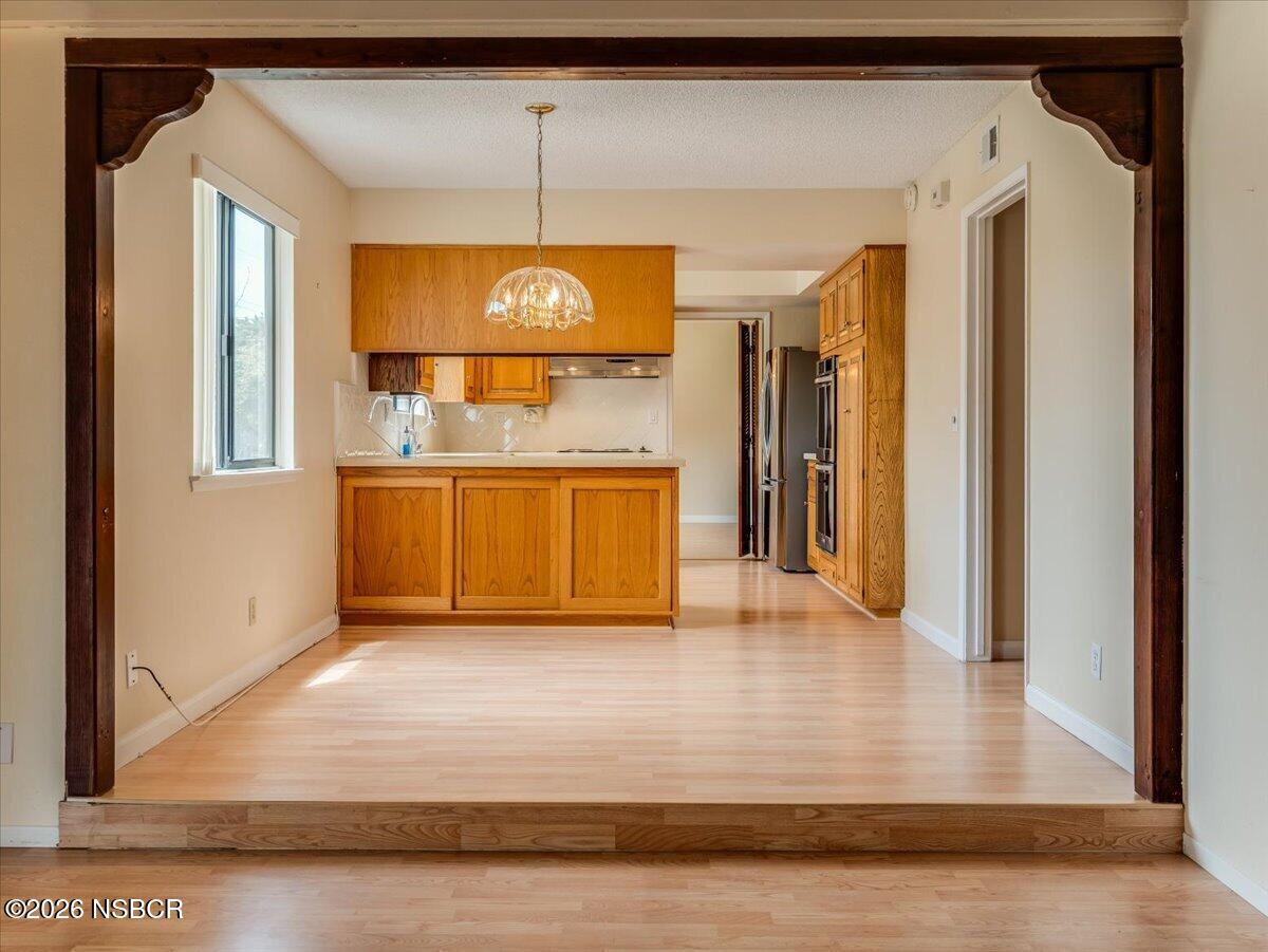 360 Tallyho Road Santa Maria, CA 93455 - Photo 26 of 72 a view of a hallway with wooden floor and a fireplace