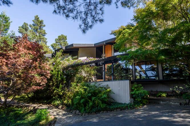 a front view of a house with a garden