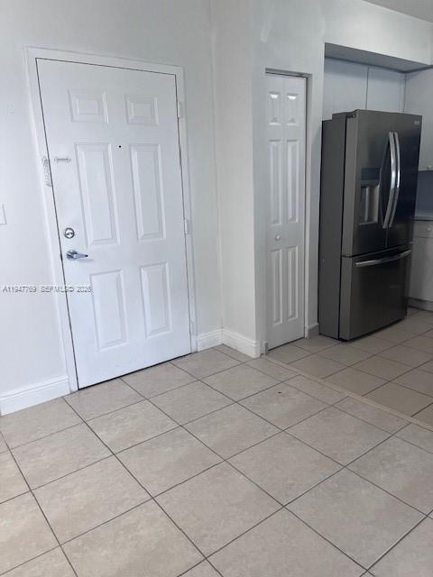 11060 Southwest 196th Street, Unit 313 Cutler Bay, FL 33157 - Photo 2 of 18 a view of a refrigerator in kitchen and white cabinets