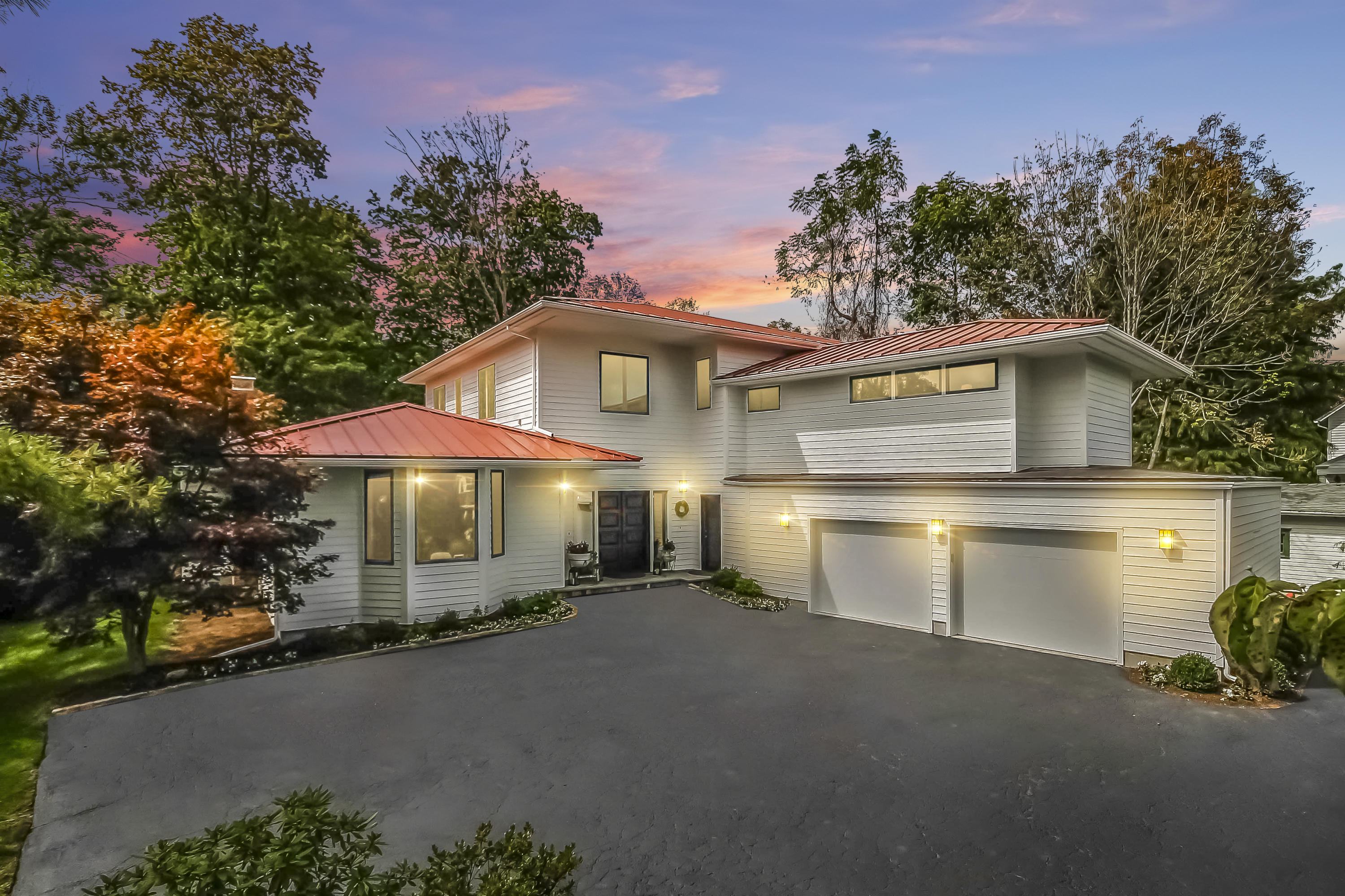 15 Marshall Ridge Road New Canaan, CT 06840 - Photo 1 of 30 a front view of a house with a yard and garage