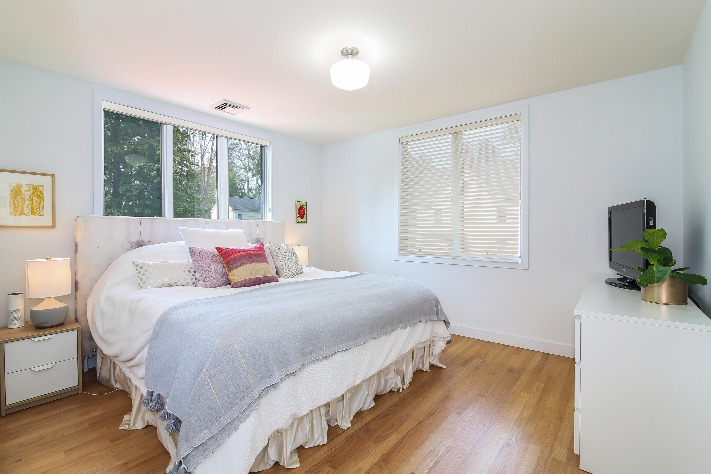 15 Marshall Ridge Road New Canaan, CT 06840 - Photo 15 of 30 a bedroom with a bed windows and a wooden floor