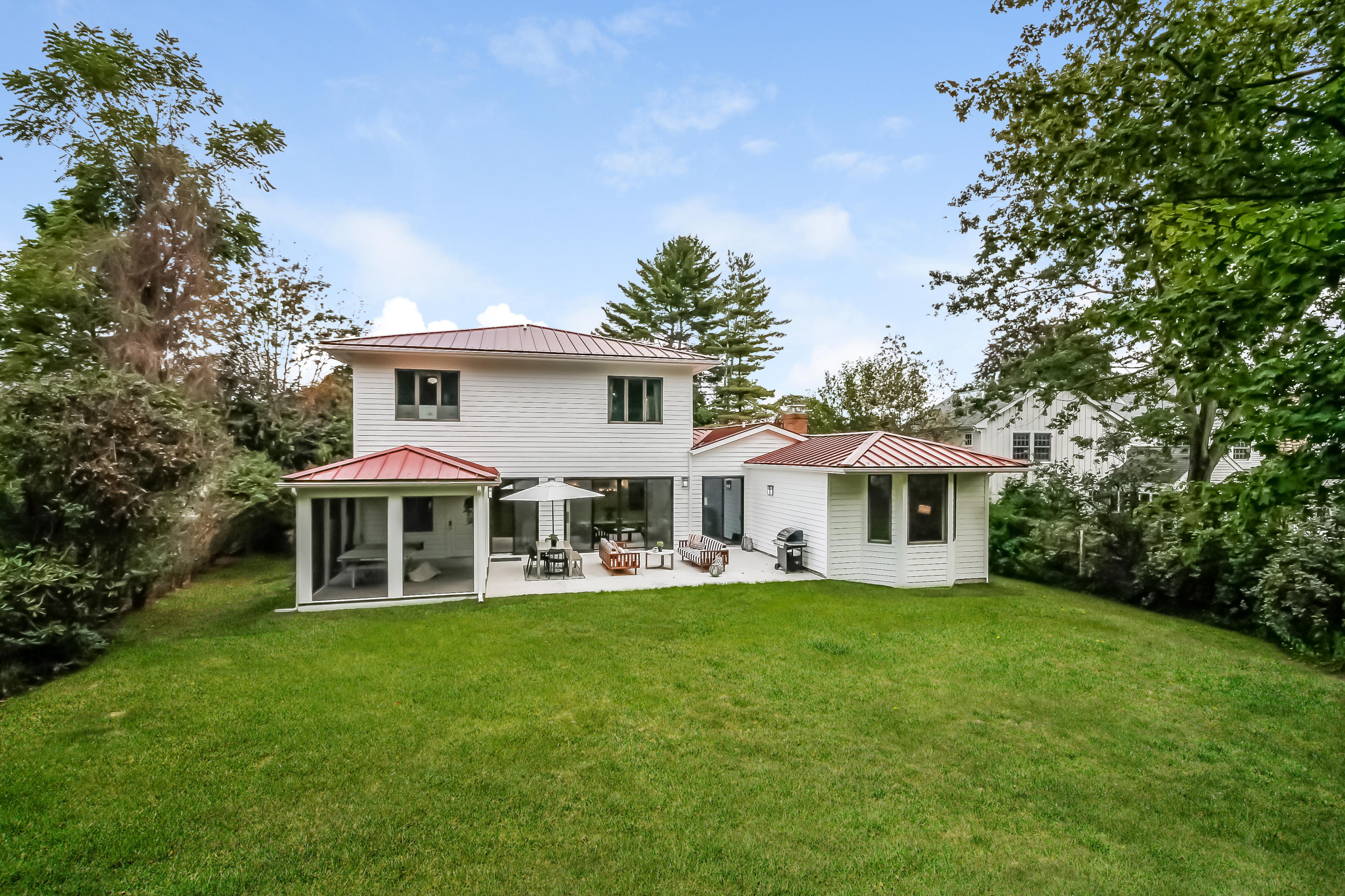 15 Marshall Ridge Road New Canaan, CT 06840 - Photo 27 of 30 a front view of a house with a yard table and chairs
