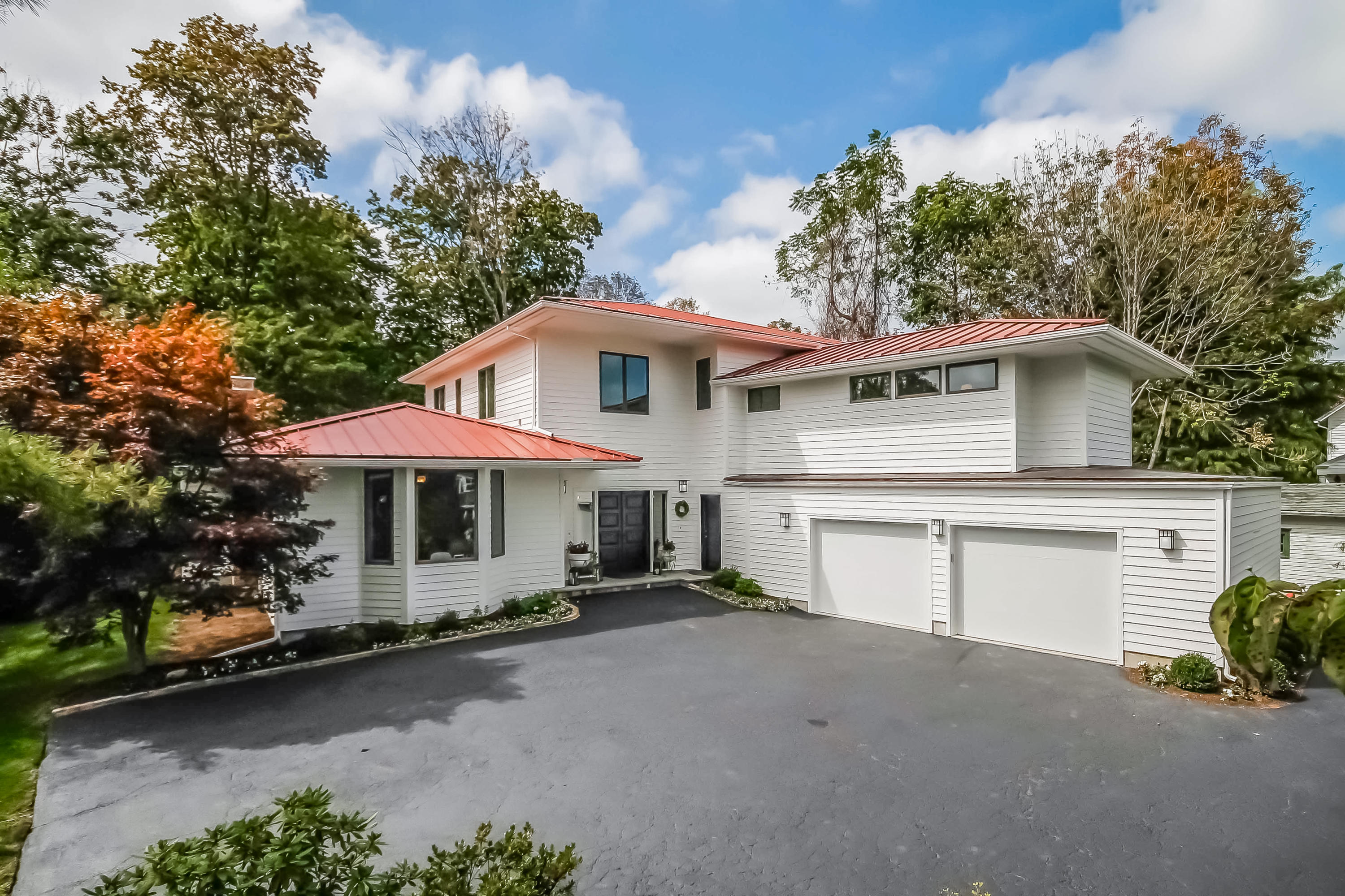 15 Marshall Ridge Road New Canaan, CT 06840 - Photo 30 of 30 a front view of a house with a yard and garage