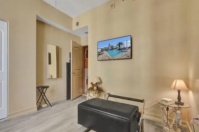 a room with gym equipment and a view of living room