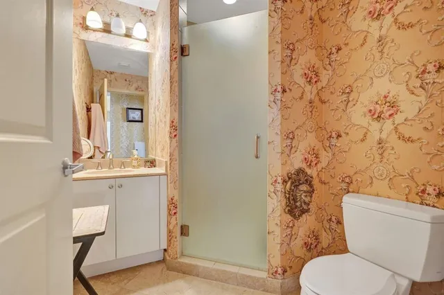 a bathroom with a toilet a sink and a mirror