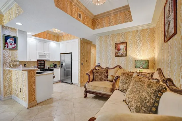 a living room with furniture and a kitchen area