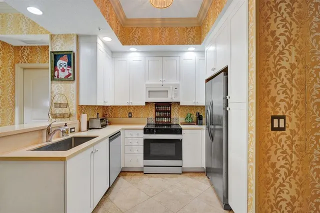 a kitchen with stainless steel appliances a sink stove and refrigerator