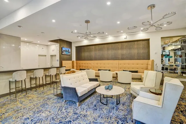 a living room with furniture a rug and a chandelier