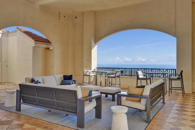a balcony with furniture and a potted plant